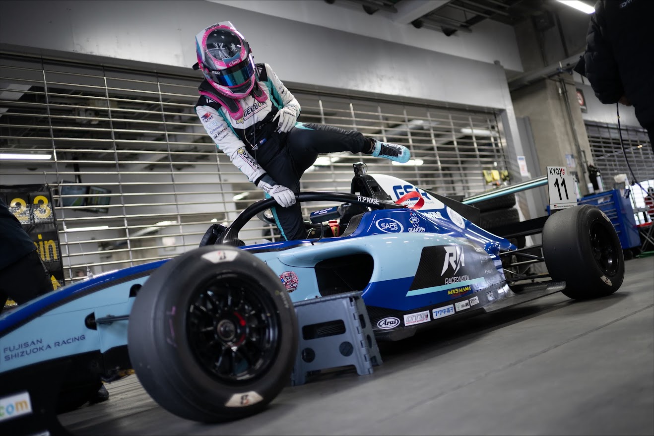 Paige Raddatz climbing into her #11 KYOJO CUP F4 car in the Fuji Speedway pit lane — 2026 season